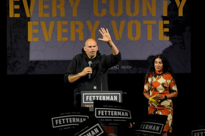 Fetterman speaks at his first post-stroke rally in Erie, Pennsylvania, on Aug. 12. His wife, Gisele Barreto Fetterman, looks on. His investment in Erie reflected his "every county, every vote" mantra.