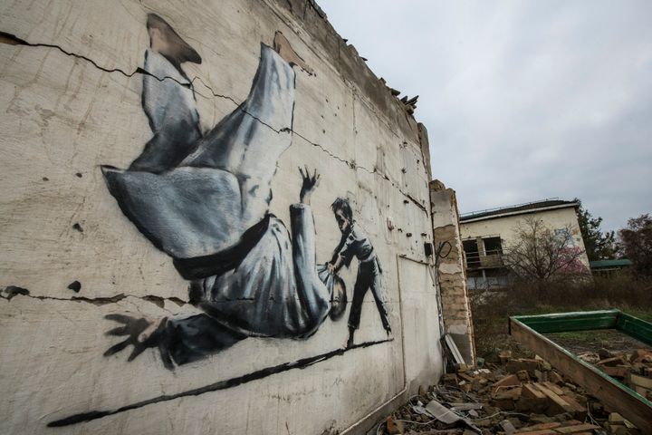 A new graffiti in Banksy style at the wall of a destroyed residental building in Borodianka, which was heavily damaged by fighting.