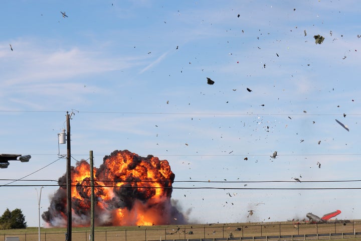 In this photo provided by Nathaniel Ross Photography, a historic military plane crashes after colliding with another plane during an airshow at Dallas Executive Airport in Dallas on Saturday, Nov. 12, 2022. (Nathaniel Ross Photography via AP)