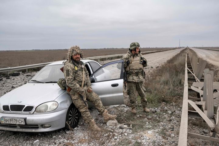 Ukrainian soldiers stand guard on the road from Mykolaiv to Kherson, on November 13, 2022, amid Russia's invasion of Ukraine.