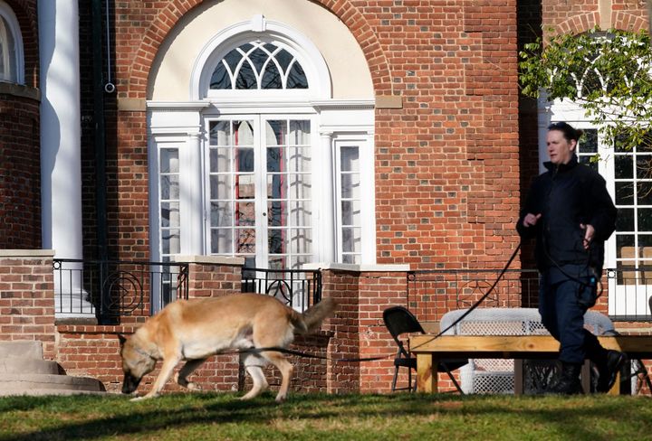 A Virginia Department of Corrections canine team searches the University of Virginia's campus on Monday.
