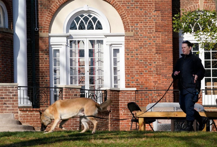 A Virginia Department of Corrections canine team searches the University of Virginia's campus on Monday.