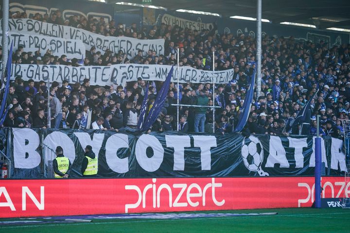 Fans in Germany at a football match hold up a banner reading "Boycott Qatar". 