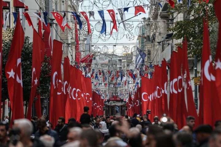 People walk in Istiklal Avenue, Istanbul, Turkey on November 14, 2022. The avenue has been decorated with Turkish flags after the deadly terror attack took place on November 13.