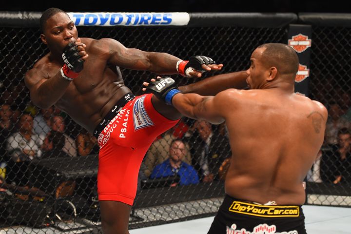 Anthony Johnson kicks Daniel Cormier in their first UFC championship bout in 2015.