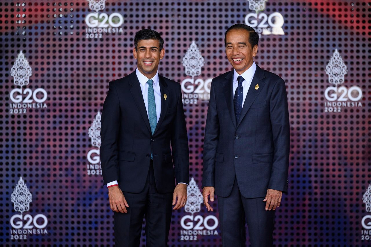 Britain's Prime Minister Rishi Sunak, left, is greeted by the Indonesia President Joko Widodo at the beginning of the G20 Summit.