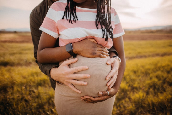 Happy couple awaiting baby. Beautiful and young parents