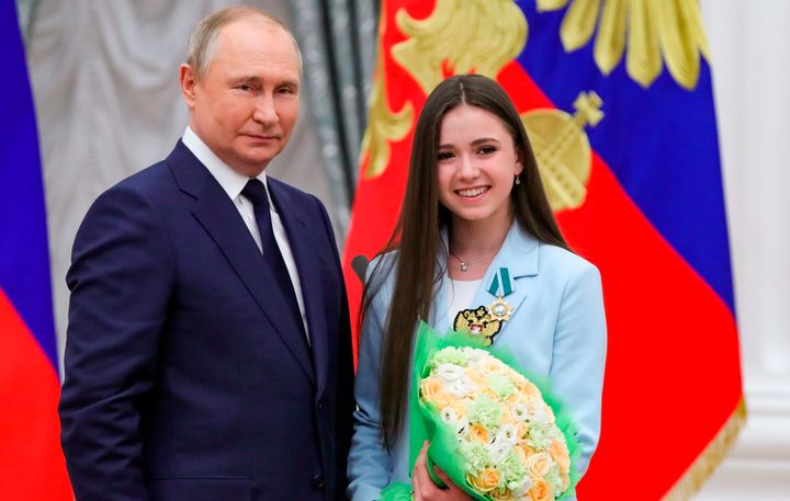 Russian President Vladimir Putin, left, poses for a photo with skater Kamila Valieva, in April 2022.