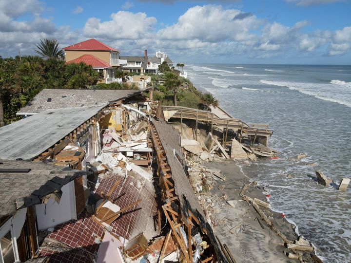 Furniture is seen inside a home that half collapsed after the sand supporting it was swept away following the passage of Hurricane Nicole on Nov. 12 in Wilbur-By-The-Sea, Florida.
