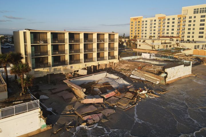 Waves lap at the damaged pool deck of the South Shore Motel, which also lost chunks of sand supporting its foundation, following the passage of Hurricane Nicole in Daytona Beach Shores, Florida.