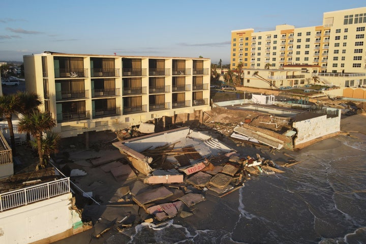 Waves lap at the damaged pool deck of the South Shore Motel, which also lost chunks of sand supporting its foundation, following the passage of Hurricane Nicole in Daytona Beach Shores, Florida.