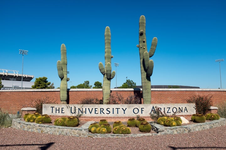 A sign in front of some cacti marks one of the entrances to the University of Arizona, in Tucson, Arizona. (Photo by Epics/Getty Images)