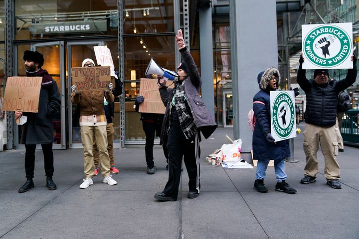 People chant and hold signs in front of a Starbucks in New York on Thursday.