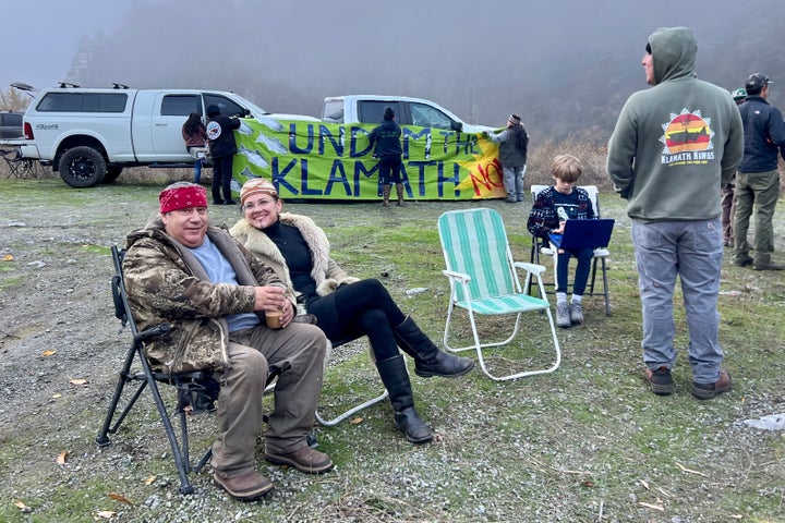 In this photo provided by Frankie Myers, members of the Yurok, Karuk and Hoopa Valley tribes and their supporters gather on a sand bar in the Klamath River near Orleans, California.