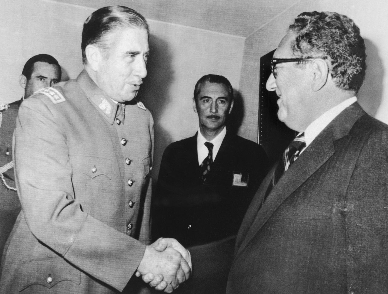 Chilean dictator Augusto Pinochet, an Army general, took power in a U.S.-supported coup in 1973 and embarked on a brutal reign of tyranny. Kissinger knew of the abuses and murders that took place on Pinochet's watch but regarded him as a defense against communism even as his contemporaries in the State Department criticized his approach.