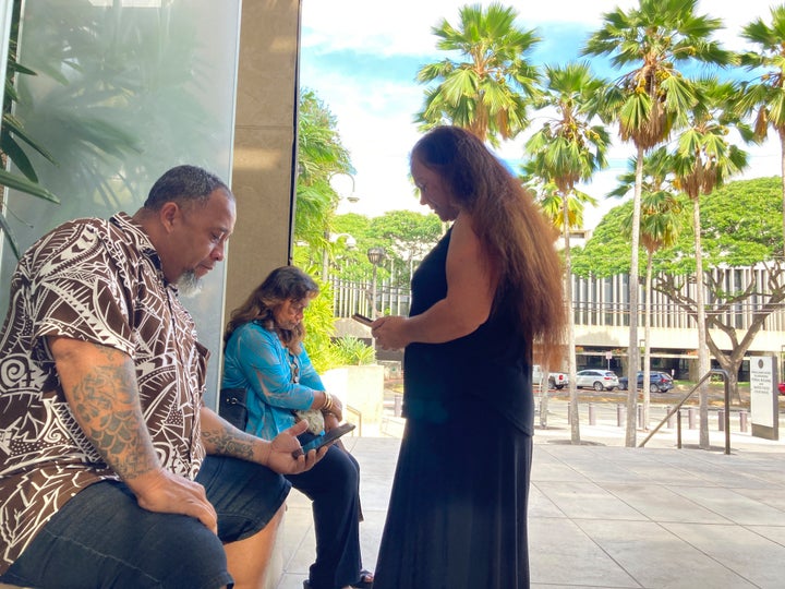 Chico Kaonohi, left, prays with Priscilla Hoʻopiʻi, center, and Lana Vierra, right, outside U.S. District Court in Honolulu, Thursday, Nov. 17, 2022, after his Native Hawaiian son was found guilty of a hate crime in the 2014 beating of a white man. U.S. District Judge J. Michael Seabright ordered Kaulana Alo-Kaonohi and Levi Aki Jr. detained pending sentencing scheduled for March 2, 2023. (AP Photo/Jennifer Sinco Kelleher)