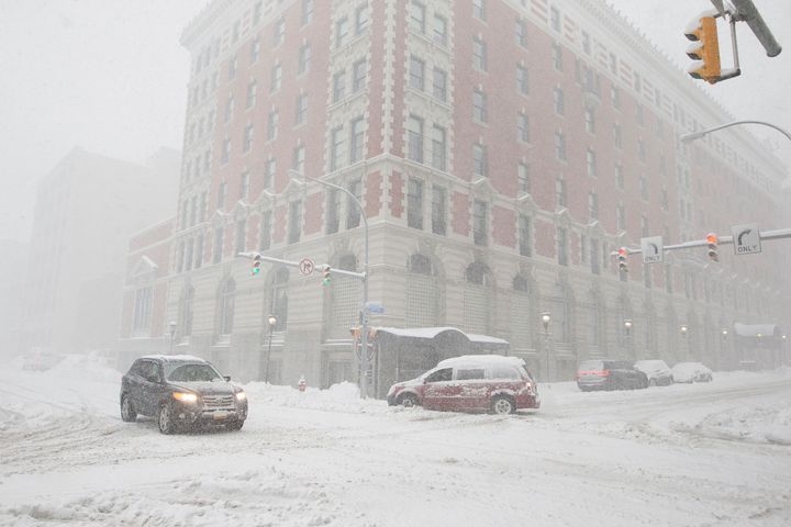 Heavy snowfall makes driving along Ellicott Street in Buffalo treacherous Friday.