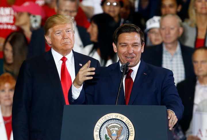 FILE- In this Nov. 3, 2018 file photo President Donald Trump stands behind gubernatorial candidate Ron DeSantis at a rally in Pensacola, Fla. (AP Photo/Butch Dill, File)