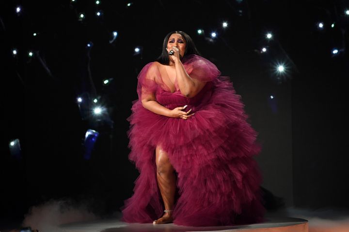 Lizzo performing at 2019 American Music Awards at Microsoft Theater on November 24, 2019 in Los Angeles, California. The singer is wearing the dress she gifted to Aurielle Marie this week. 