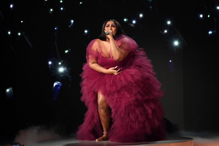 Lizzo performing at 2019 American Music Awards at Microsoft Theater on November 24, 2019 in Los Angeles, California. The singer is wearing the dress she gifted to Aurielle Marie this week. 