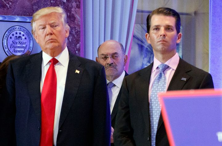 FILE - In this Jan. 11, 2017 file photo, Allen Weisselberg, center, stands between President-elect Donald Trump, left, and Donald Trump Jr., at a news conference in the lobby of Trump Tower in New York. (AP Photo/Evan Vucci, File)