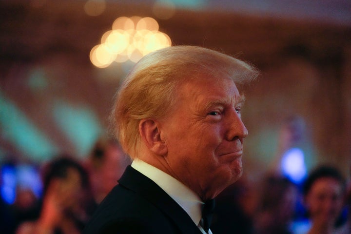 Former President Donald Trump smiles toward guests, as he arrives to speak at an event at Mar-a-Lago, Friday, Nov. 18, 2022, in Palm Beach, Fla. Earlier in the day Attorney General Merrick Garland named a special counsel to oversee the Justice Department's investigation into the presence of classified documents at Trump's Florida estate and aspects of a separate probe involving the Jan. 6, 2021, insurrection and efforts to undo the 2020 election. (AP Photo/Rebecca Blackwell)