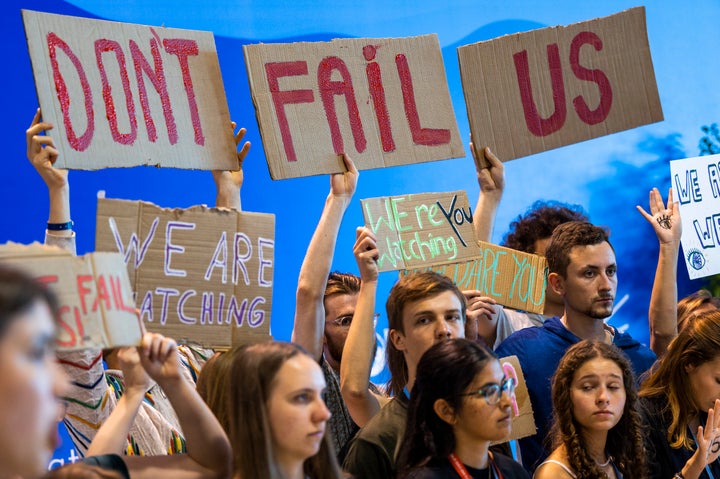 dpatop - 19 November 2022, Egypt, Scharm El Scheich: Participants in a demonstration at the UN Climate Summit COP27 hold placards and advocate for the 1.5 degree Celsius global temperature rise target. Photo: Christophe Gateau/dpa (Photo by Christophe Gateau/picture alliance via Getty Images)