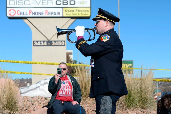 Michael Robert Travis performs taps while his husband, Michael Travis, films on his phone near Club Q following Saturday's shooting.