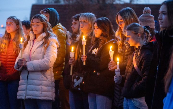 Boise State University students, along with people who knew the four University of Idaho students who were found killed in Moscow, Idaho, days earlier, pay their respects at a vigil held in front of a statue on the Boise State campus.