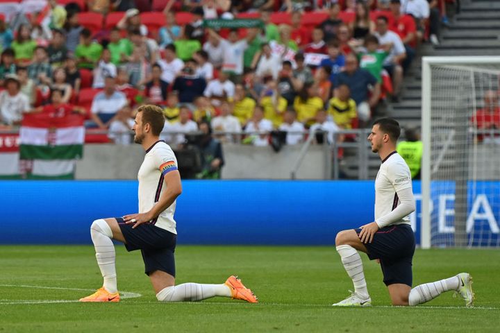 2022年6月の国際試合で片膝をつく行為をするイングランドのケイン選手（左）