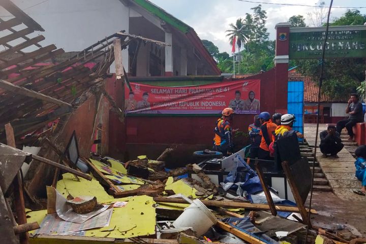 In photo released by Indonesian National Search and Rescue Agency, rescuers inspect a school damaged by earthquake in Cianjur, West Java, Indonesia, on Nov. 21, 2022. 