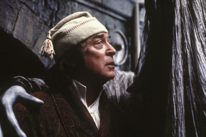 Scrooge and the Ghost of Christmas Yet To Come in one of the film's most unsettling sequences