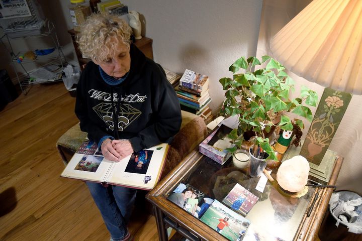 Sabrina Aston looks at childhood photos of her 28-year-old son, Daniel Aston, at her home in Colorado Springs, Colorado on Sunday, November 20, 2022.