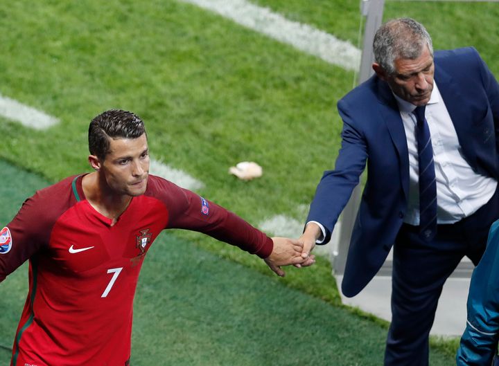 FILE - Portugal's Cristiano Ronaldo, left, greets Portugal coach Fernando Santos at the end of the Euro 2016 Group F soccer match between Portugal and Iceland at the Geoffroy Guichard stadium in Saint-Etienne, France, on June 14, 2016. The last 32-team World Cup will be the shortest in this era. There are just 28 days from starting on Nov. 21 in Qatar to finishing on Dec. 18. And only 25 days to play seven games if a team from Groups G or H – like Brazil or Portugal – is to reach the final after opening on Nov. 24. (AP Photo/Michael Sohn, File)
