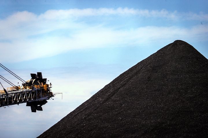 An excavator is pictured next to a mound of coal at the Port of Newcastle, in New South Wales, Australia.