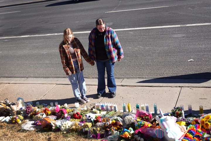 People visit a makeshift memorial near Club Q on Monday.
