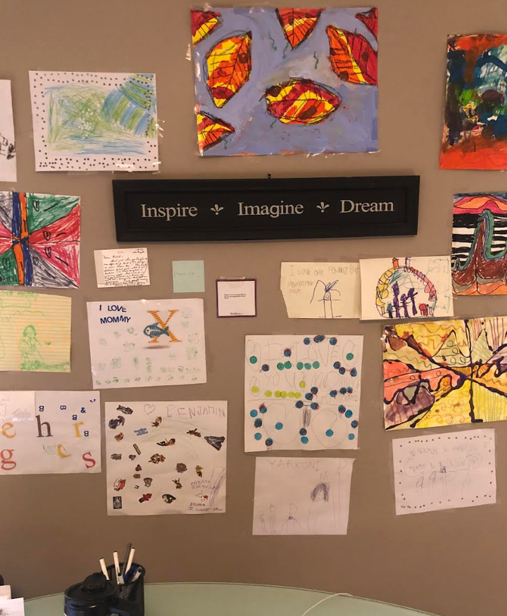 A space above the author's desk where she displays her children's artwork.