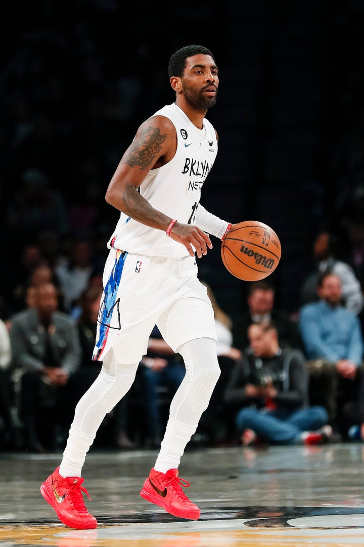 Brooklyn Nets guard Kyrie Irving dribbles against the Memphis Grizzlies during the first half of an NBA basketball game Sunday in New York.