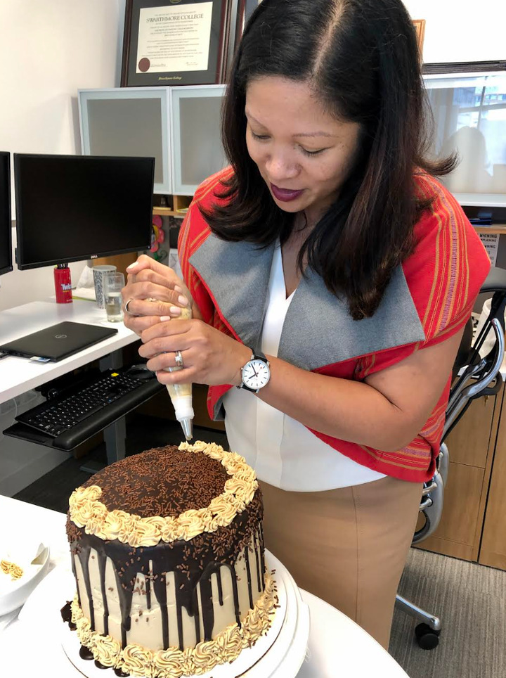 The author piping finishing touches before an office party. "This is a photo from my dormant Instagram account," she writes.