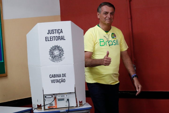 Brazilian President Jair Bolsonaro, who is running for another term, gives a thumbs up after voting in a run-off presidential election in Rio de Janeiro, Brazil, Sunday, Oct. 30, 2022. (AP Photo/Bruna Prado, Pool)