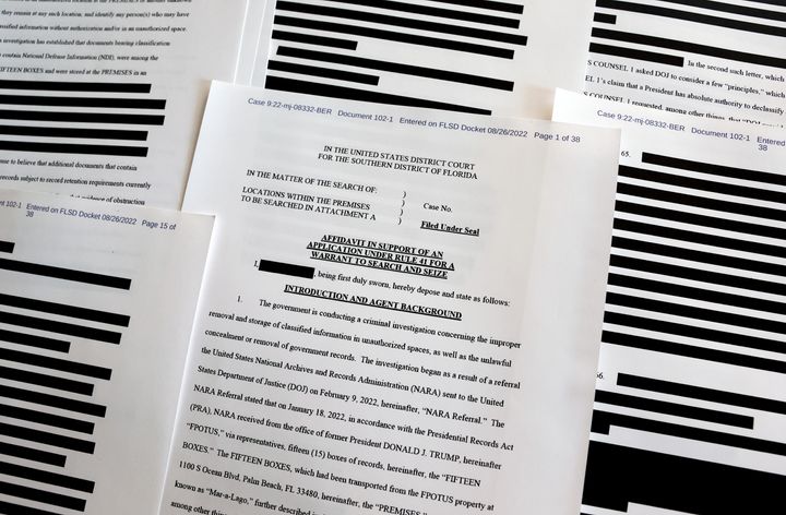 CALIFORNIA - AUGUST 27: In this photo illustration, pages are viewed from the government’s released version of the F.B.I. search warrant affidavit for former President Donald Trump's Mar-a-Lago estate on August 27, 2022 in California. The 32-page affidavit was heavily redacted for the protection of witnesses and law enforcement and to ensure the ‘integrity of the ongoing investigation’. (Photo Illustration by Mario Tama/Getty Images)