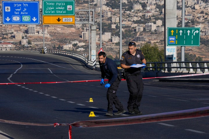 Israeli police inspect the scene of an explosion at a bus stop in Jerusalem, on Nov. 23, 2022.