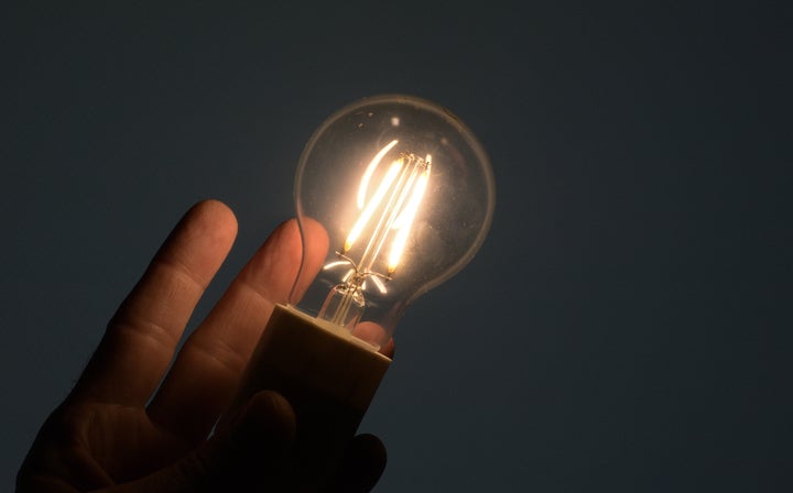 Holding a led lamp bulb on a hand