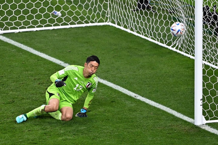 TOPSHOT - Japan's goalkeeper #12 Shuichi Gonda concedes a penalty during the Qatar 2022 World Cup Group E football match between Germany and Japan at the Khalifa International Stadium in Doha on November 23, 2022. (Photo by Anne-Christine POUJOULAT / AFP) (Photo by ANNE-CHRISTINE POUJOULAT/AFP via Getty Images)