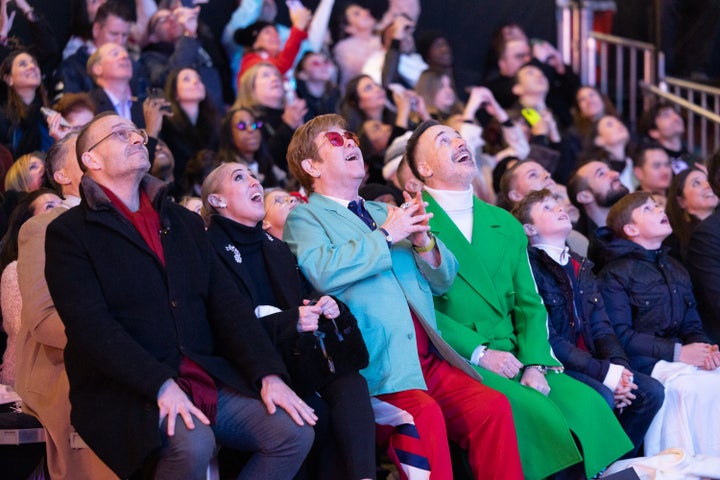 After his performance, John (center, in blue) sat down with his family to enjoy the Christmas lights.