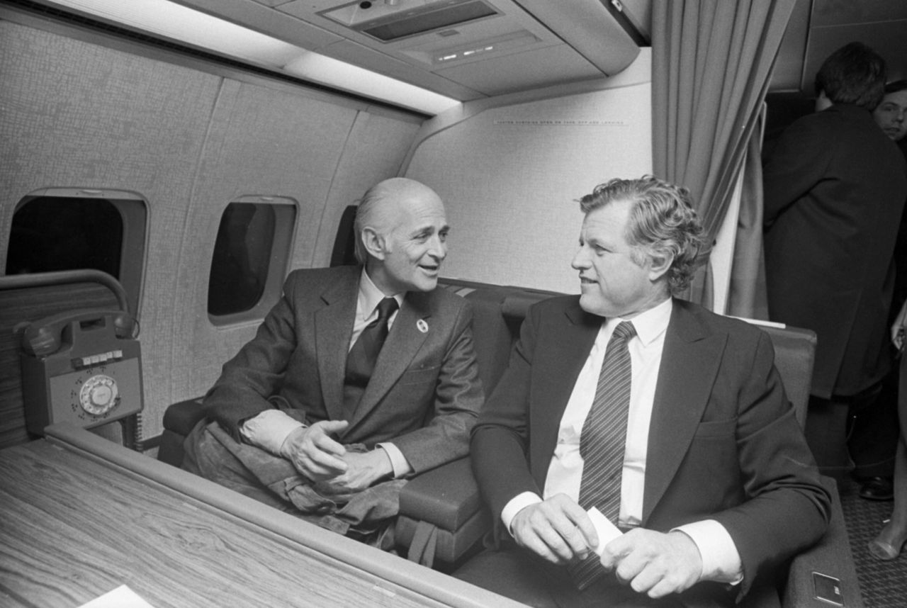 Lear gets a laugh from Sen. Edward Kennedy as the two talk aboard Kennedy's campaign plane flying over Iowa. Lear joined the Kennedy entourage during the Democratic presidential candidate's Iowa swing, traveling as what Lear termed "an observer" in Sioux City, Iowa, on Dec. 7, 1979.