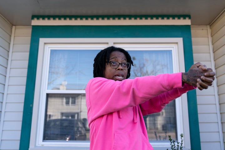 Briana Tyler speaks with The Associated Press and uses her hands like a gun as she demonstrates the gunman shooting indiscriminately, as she talks about witnessing the mass shooting at a Walmart, Wednesday, Nov. 23, 2022, in Chesapeake, Va. 