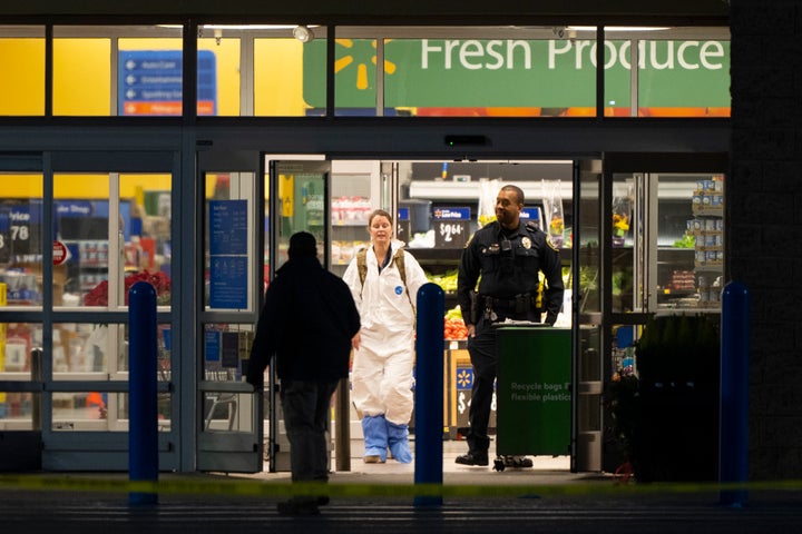 A law enforcement investigator wears a protective covering as they work the scene of a mass shooting at a Walmart, on Nov. 23, 2022, in Chesapeake, Va.