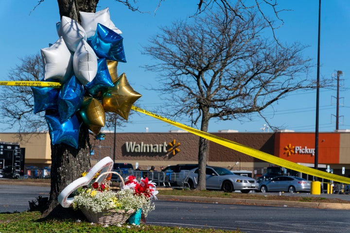 Flowers and balloons are placed near the scene of a mass shooting at a Walmart, Wednesday, Nov. 23, 2022, in Chesapeake, Virginia.