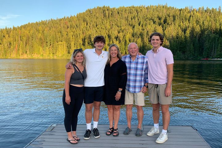 In this photo provided by Stacy Chapin, triplets Maizie, left, Ethan, second from left, and Hunter, right, pose with their parents Stacy and Jim Chapin at Priest Lake in northern Idaho in July 2022. Ethan Chapin was one of four University of Idaho students found stabbed to death in a home near the Moscow, Idaho campus on Nov. 13, 2022. Police are still searching for a suspect in the case.